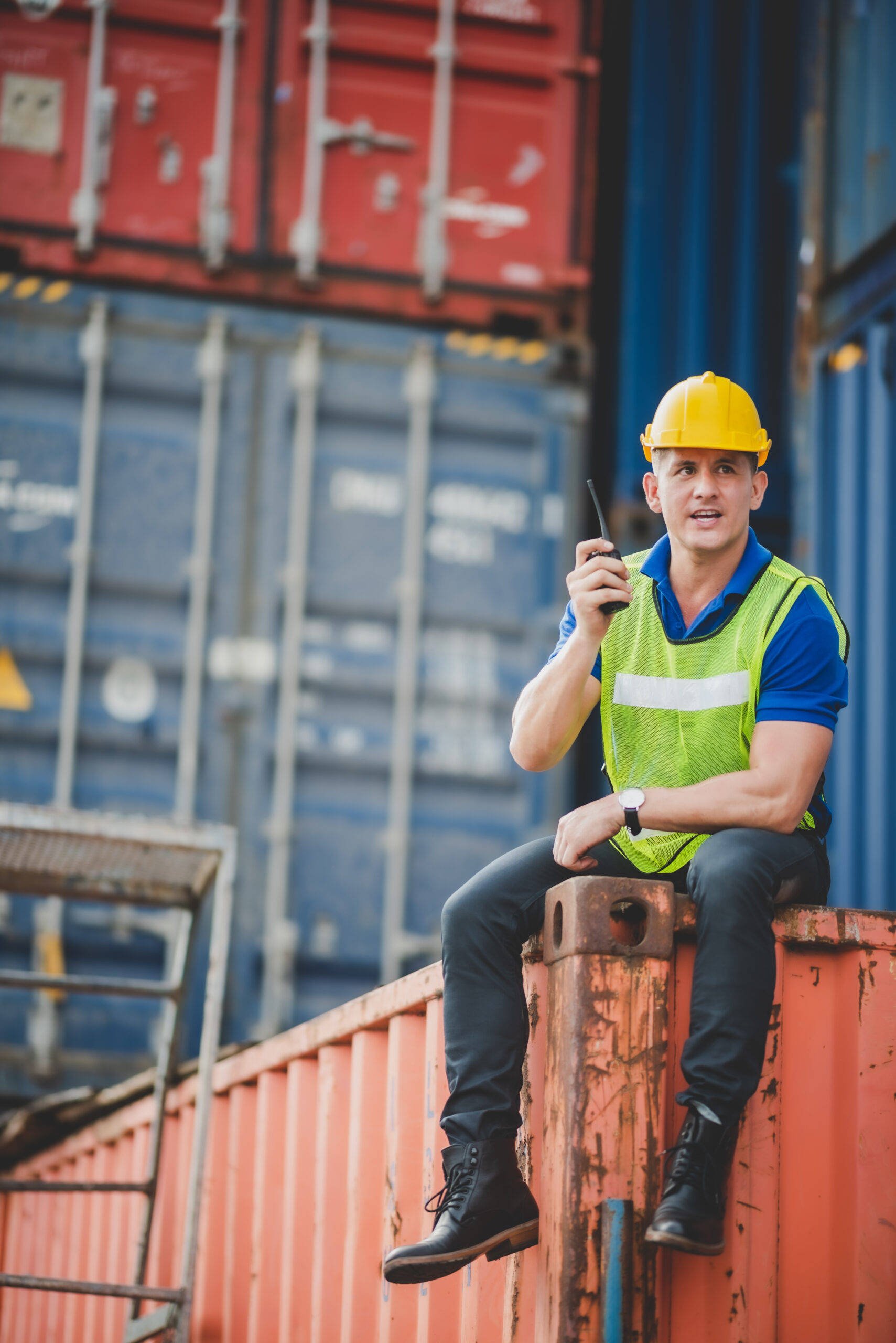 engineer foreman working in container terminal in term of industry logistic cargo shipping to export and import, warehouse delivery business freight transport, loading control in port with safety