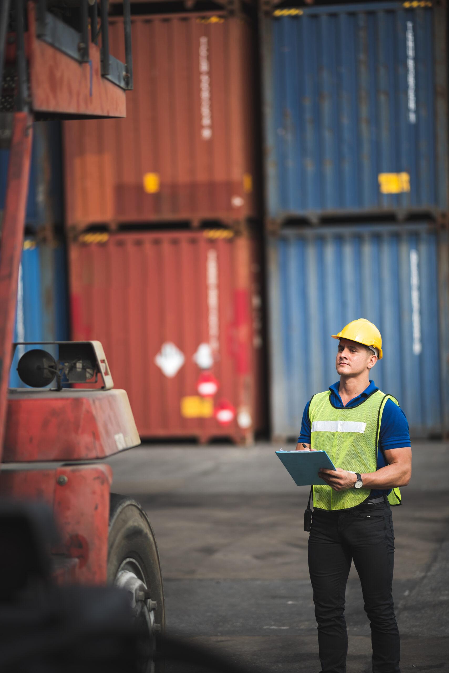 Quality control Inspector checking on container site, logistic store for import and export concept, Check the availability of industrial machinery.