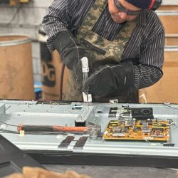 Man disassembling electronic components