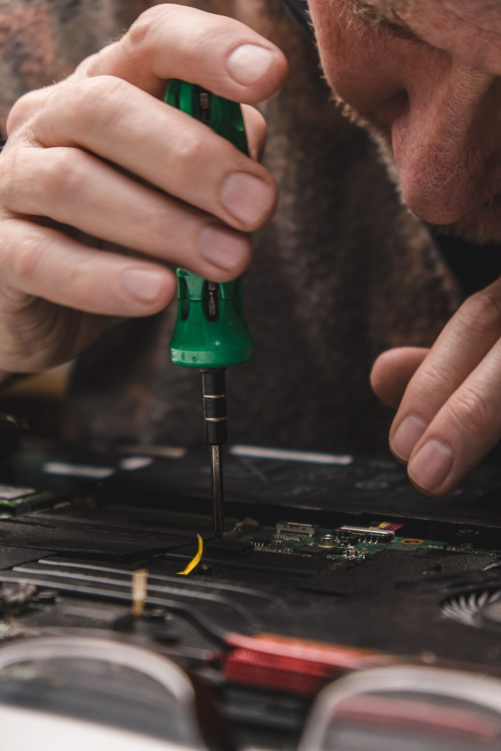Computer repair specialist installing laptop components