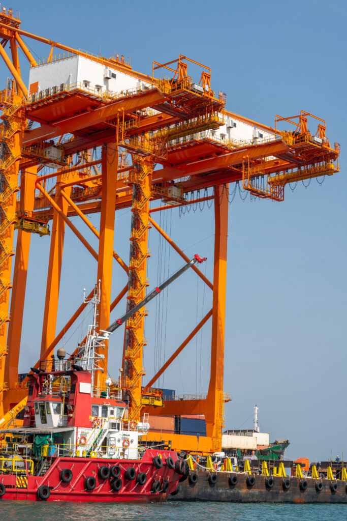 crane loading cargo container from truck to container ship in the international terminal logistic sea port concept freight shipping by ship, webinar banner forwarder mast